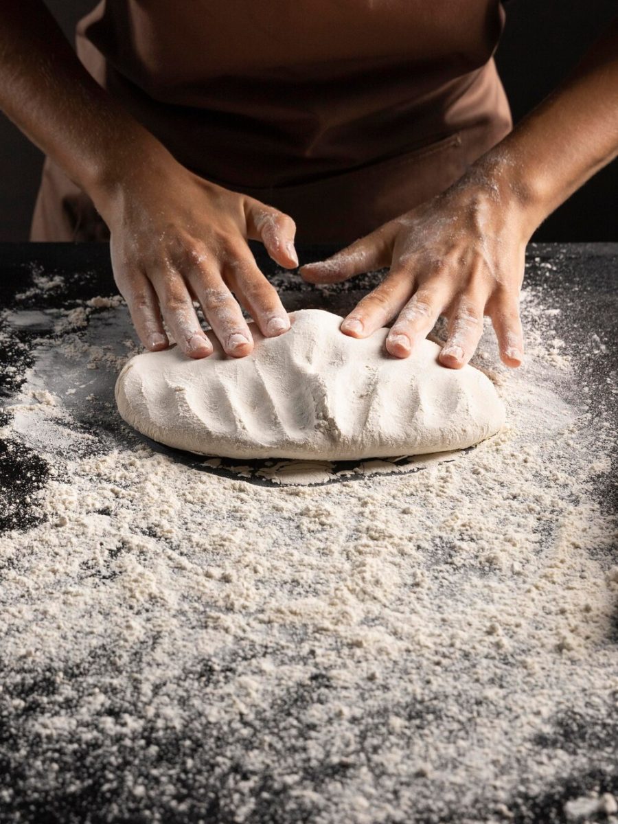 chef-kneading-dough-table_23-2148742165